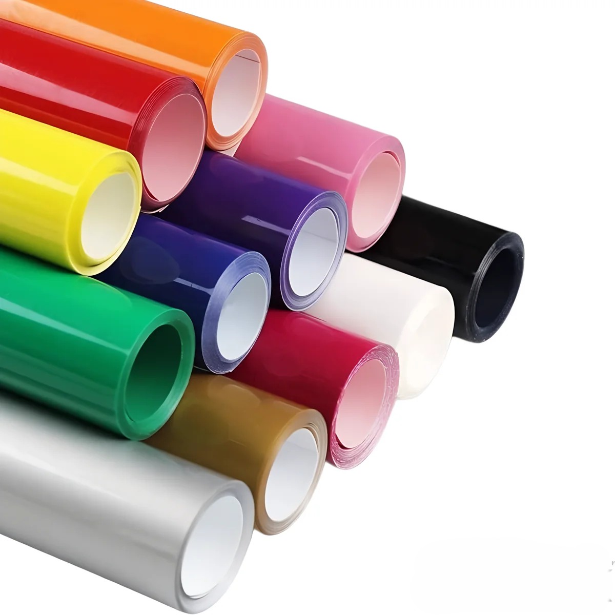 Heat transfer vinyl rolls beside a sports jersey